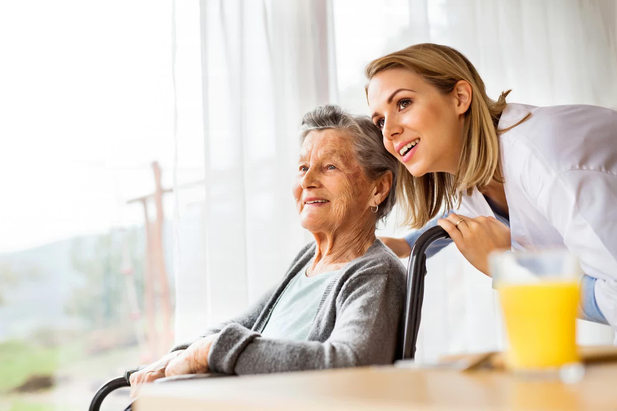 Compassionate caregiver with elderly woman