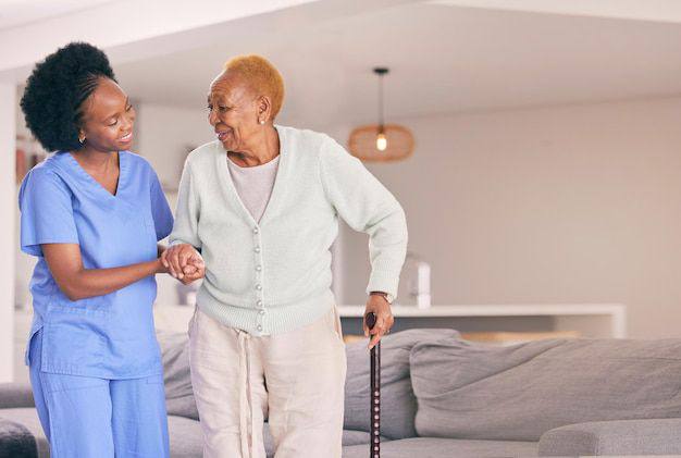 Caregiver helping elderly woman walk